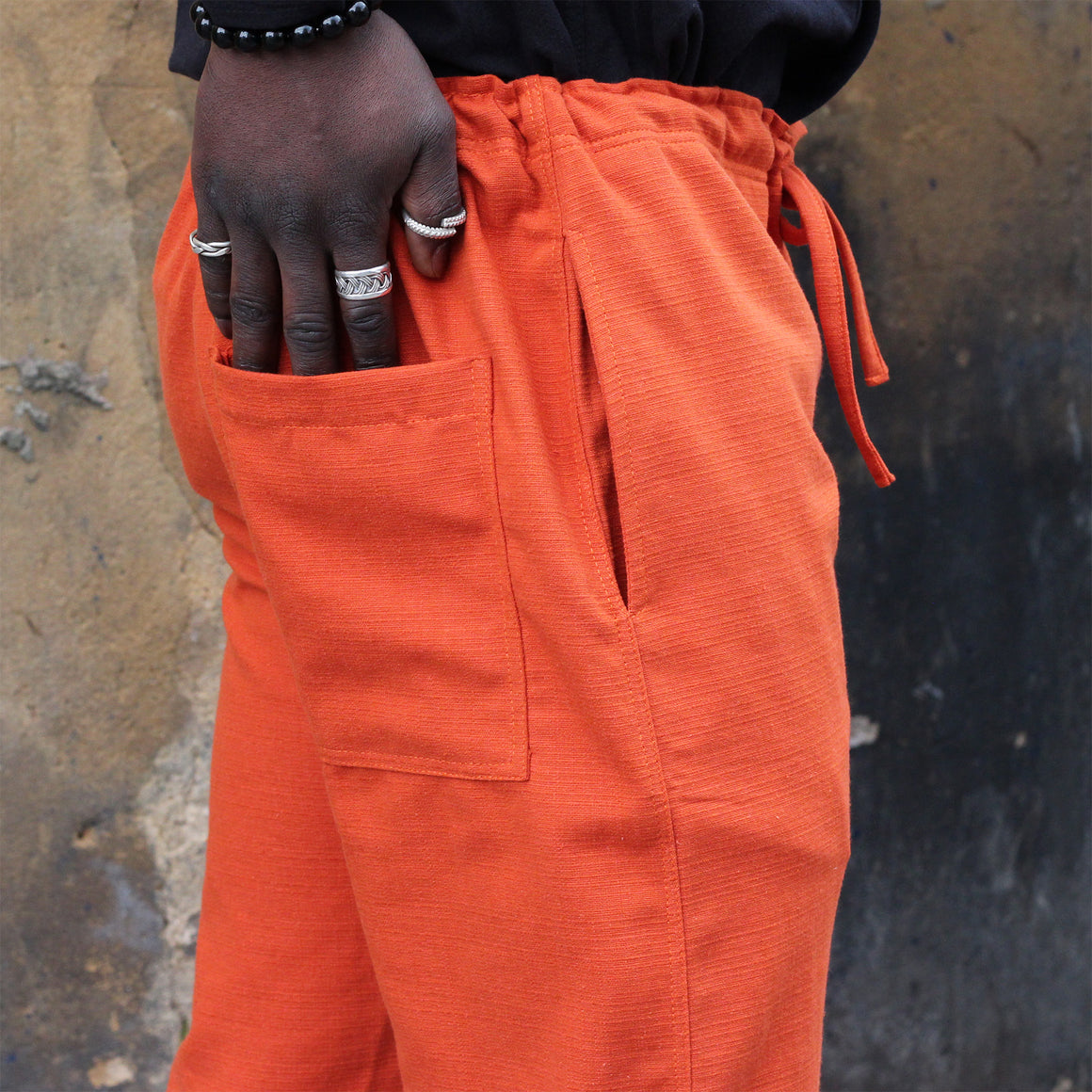 Unisex Ribbed Cotton Shing Mai Trousers Orange front, on model