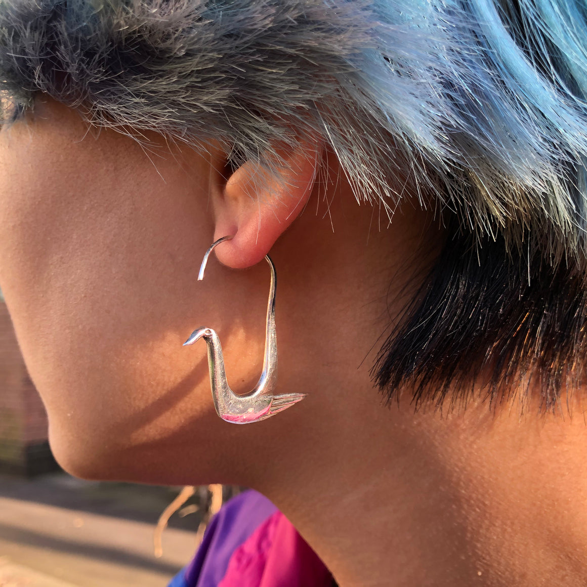 Fair trade handmade Indian silver swan earrings on stand
